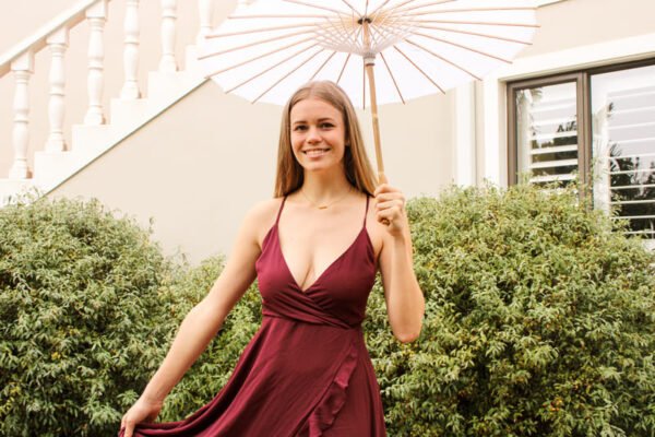 Rent the Flowy Maroon long maroon dress with frills, adjustable straps, and tie-back in Stellenbosch, South Africa from Rokkies.