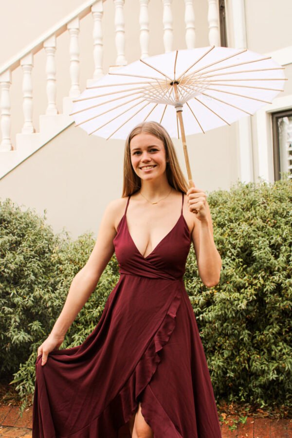 Rent the Flowy Maroon long maroon dress with frills, adjustable straps, and tie-back in Stellenbosch, South Africa from Rokkies.