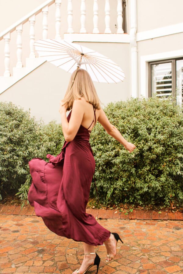 Rent the Flowy Maroon long maroon dress with frills, adjustable straps, and tie-back in Stellenbosch, South Africa from Rokkies.