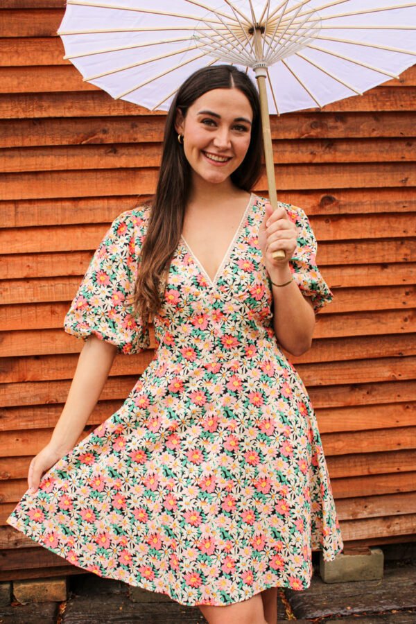 Rent the Joybells short puff sleeve dress with red, yellow, and white flowers and a deep V neckline in Stellenbosch, South Africa from Rokkies.