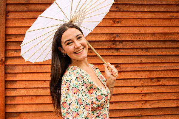 Rent the Joybells short puff sleeve dress with red, yellow, and white flowers and a deep V neckline in Stellenbosch, South Africa from Rokkies.